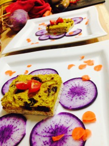 Sauerkraut Quiche with sun dried Tomatoes and sliced purple daikon, sprinkled with carrot confetti. *raw, vegan and gluten free*