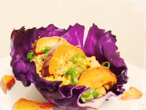 Fiesta Chipotle Corn Salad with roasted Yams, spring onions on a purple cabbage leaf. *organic,vegan and gluten free*